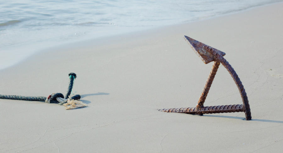 An anchor sticking into the beach