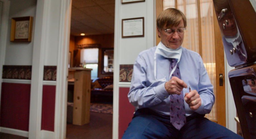 Dr. David Skarin in the operatory room bending wire for an orthodontic appliance