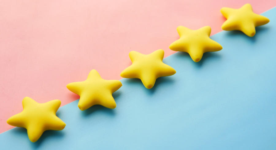 A close up view of five gold stars on a colorful background