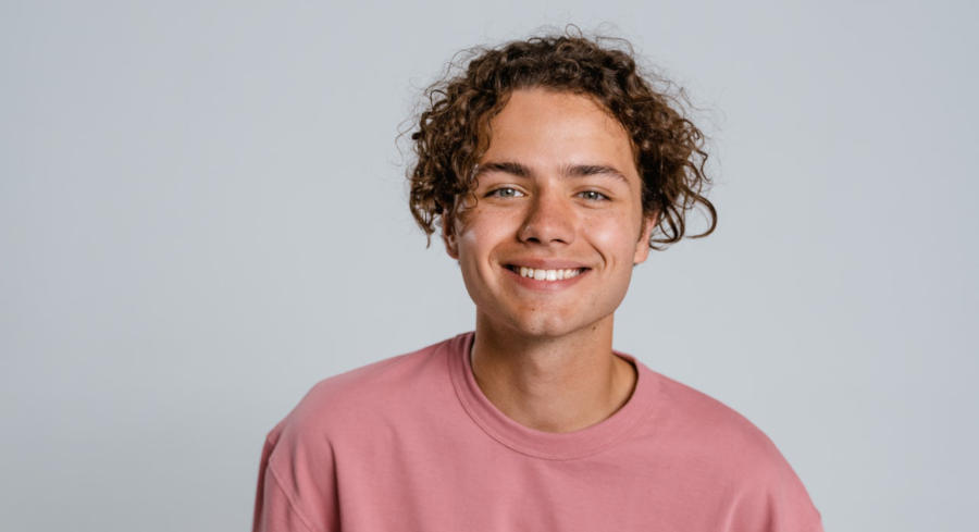 Teenager in pink shirt smiling