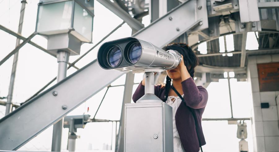 A woman looking through a telescope